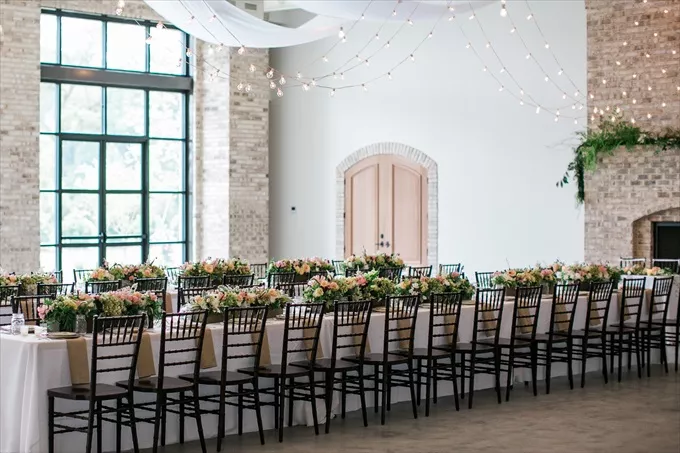 draping decor above wedding reception table and string lights