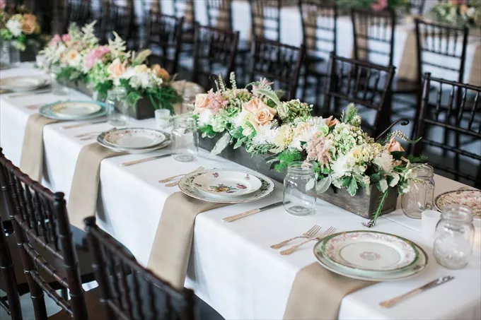 wedding reception table decor setup with elegant flower centerpieces
