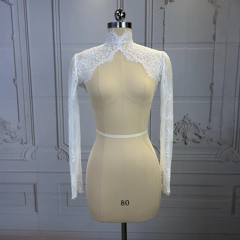 Light ivory lace wedding dress topper with long sleeves and a high neckline