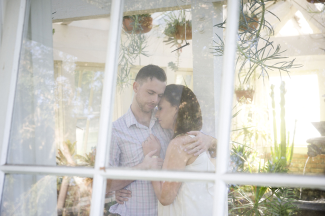 Santa Fe Springs Engagement Session with couple holding each other in greenhouse