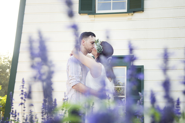engagement session kiss by flowers in Santa Fe Springs