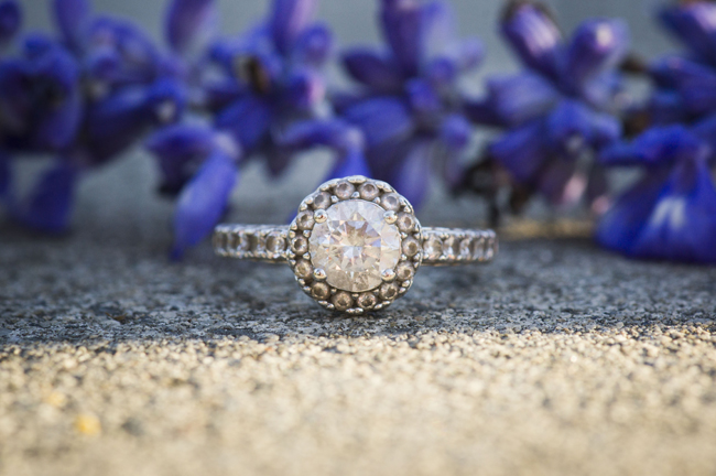 engagement ring with purple flowers in the background