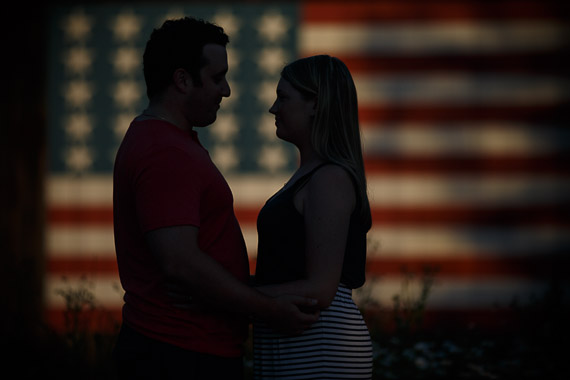 Annie & Josh's Engagement - engaged couple in front of American flag