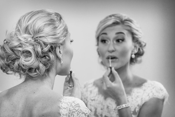 Wedding of Caitlin & Ben at The Villa - bride applying makeup