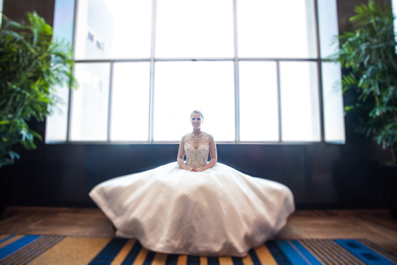 bride sitting in wedding dress at Lowes Hotel - Crystal Tea Room Wedding - photo: Daniel Fugaciu Photography | via https://emmalinebride.com