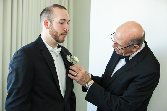 groom's father pins boutineer - Crystal Tea Room Wedding - photo: Daniel Fugaciu Photography | via https://emmalinebride.com