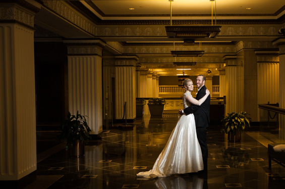bride and groom pose in Lowes Hotel Lobby - Crystal Tea Room Wedding - photo: Daniel Fugaciu Photography | via https://emmalinebride.com