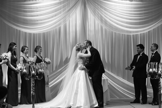bride kisses groom at alter - photo: Daniel Fugaciu Photography | via https://emmalinebride.com