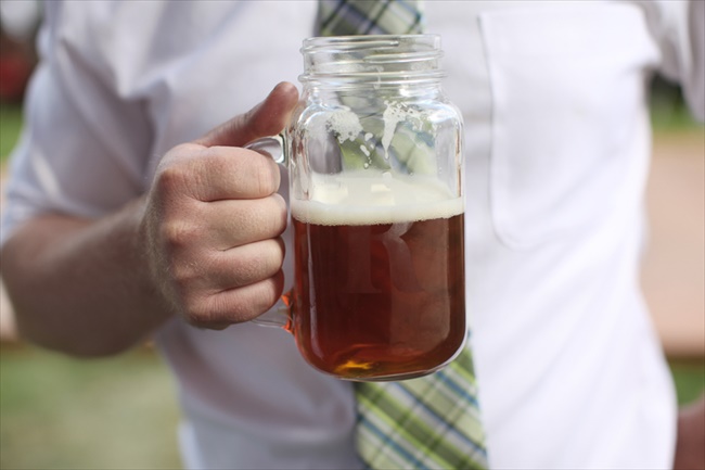 Mason Jar Beer Mug held by guest at wedding reception