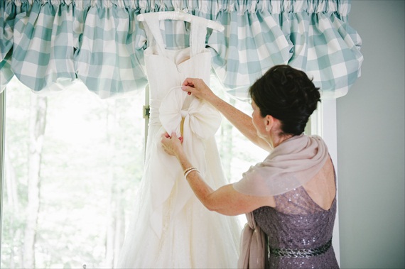 bride's mom adjusting bow on wedding dress - michelle gardella photography - Handmade Connecticut Wedding