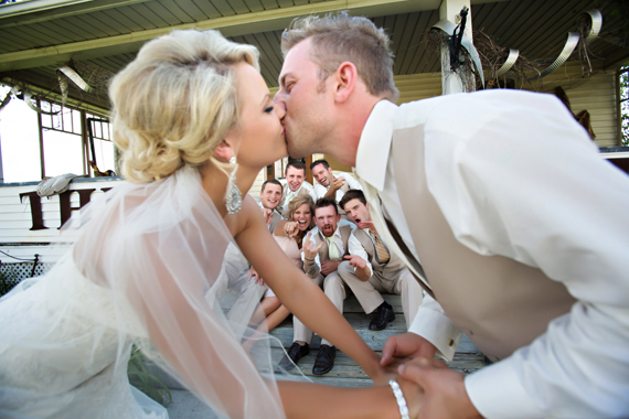 KimAnne Photography - iowa backyard wedding - bride-groom-kiss-bridal-party
