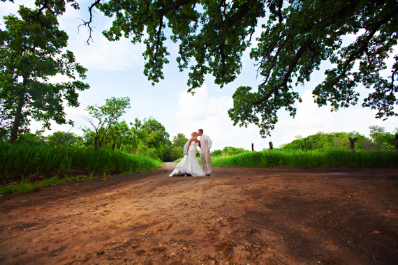 KimAnne Photography - iowa backyard wedding - bride-kissing-groom-on-farm