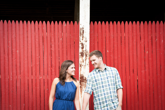 Scott Smith Photography - engaged couple standing by red picket fence
