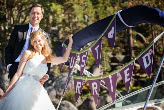 Johnstone Studios - lake tahoe wedding - bride and groom on the boat with just married purple bunting