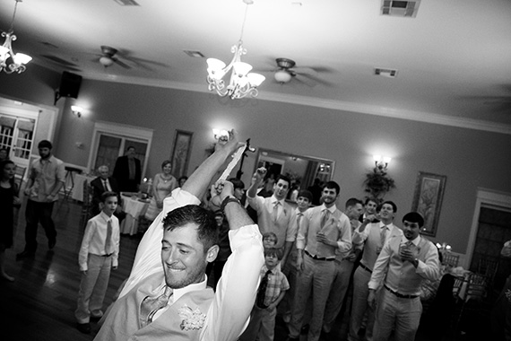 Tate Tullier Photography - Gatehouse wedding - groom-launches-the-garter