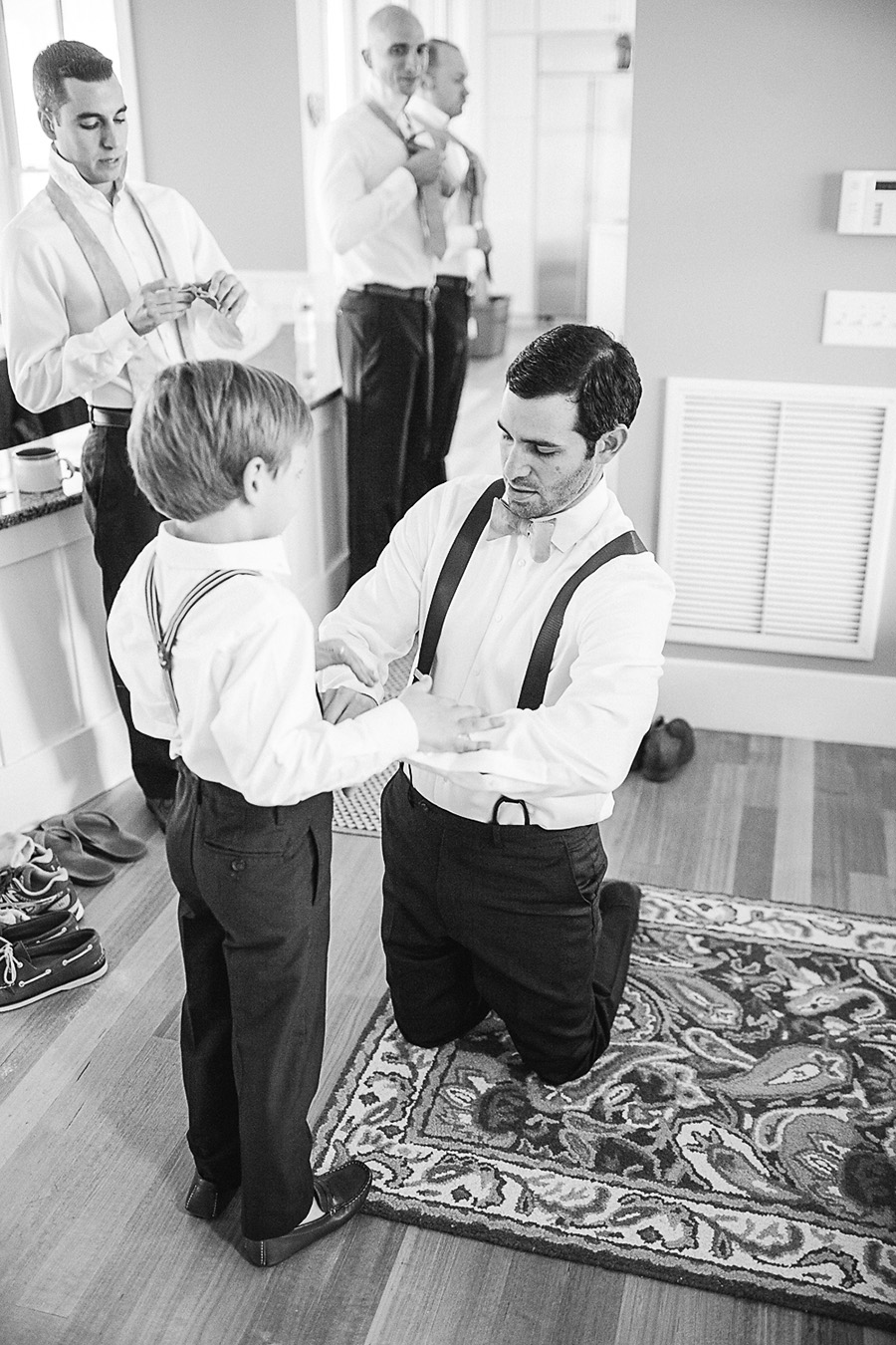 The Groom Helping the Ring Bearer Get Ready - Bald Head Island Wedding - Photo by Eric Boneske