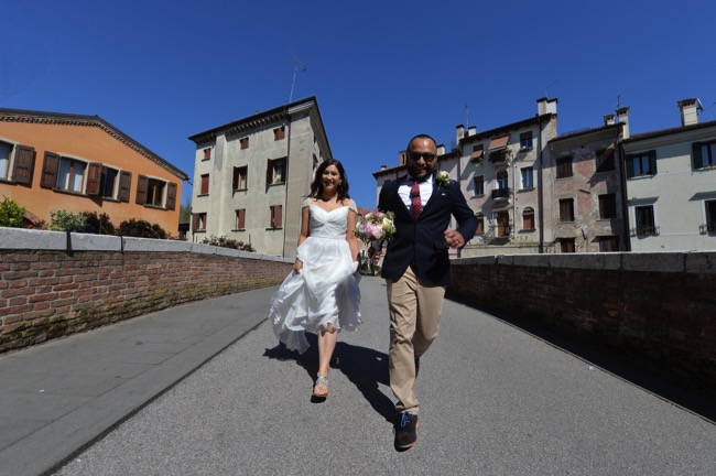 bride and groom run over bridge | Planner: Venice Events | via https://emmalinebride.com/real-weddings/spring-wedding-in-italy-andre-shona/
