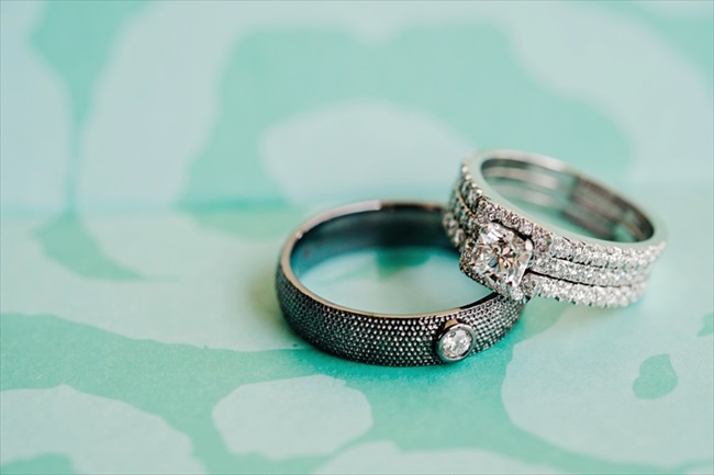 the bride and groom's wedding rings on a tiffany blue background