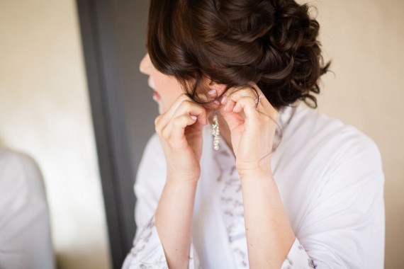 Winery Styled Wedding Shoot - The Bride in Robe Putting on Earrings