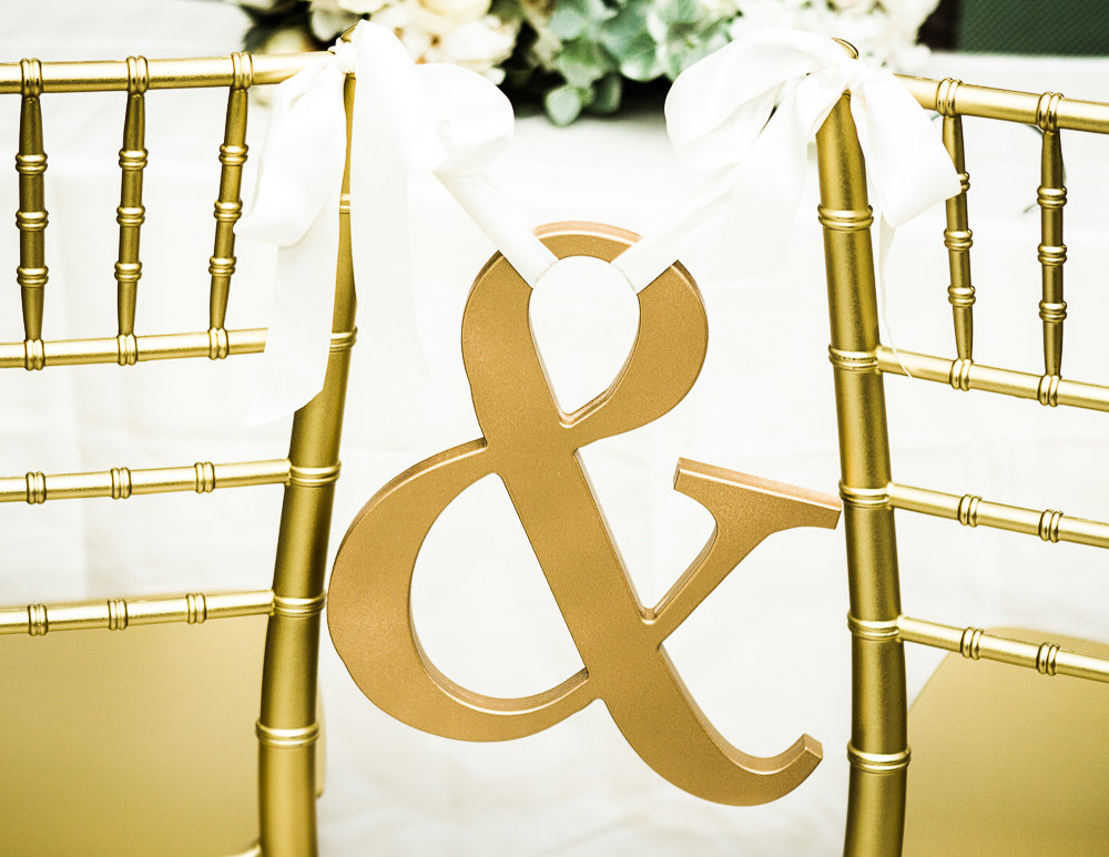 ampersand gold chair sign | via bride and groom chair signs https://emmalinebride.com/decor/bride-and-groom-chairs/