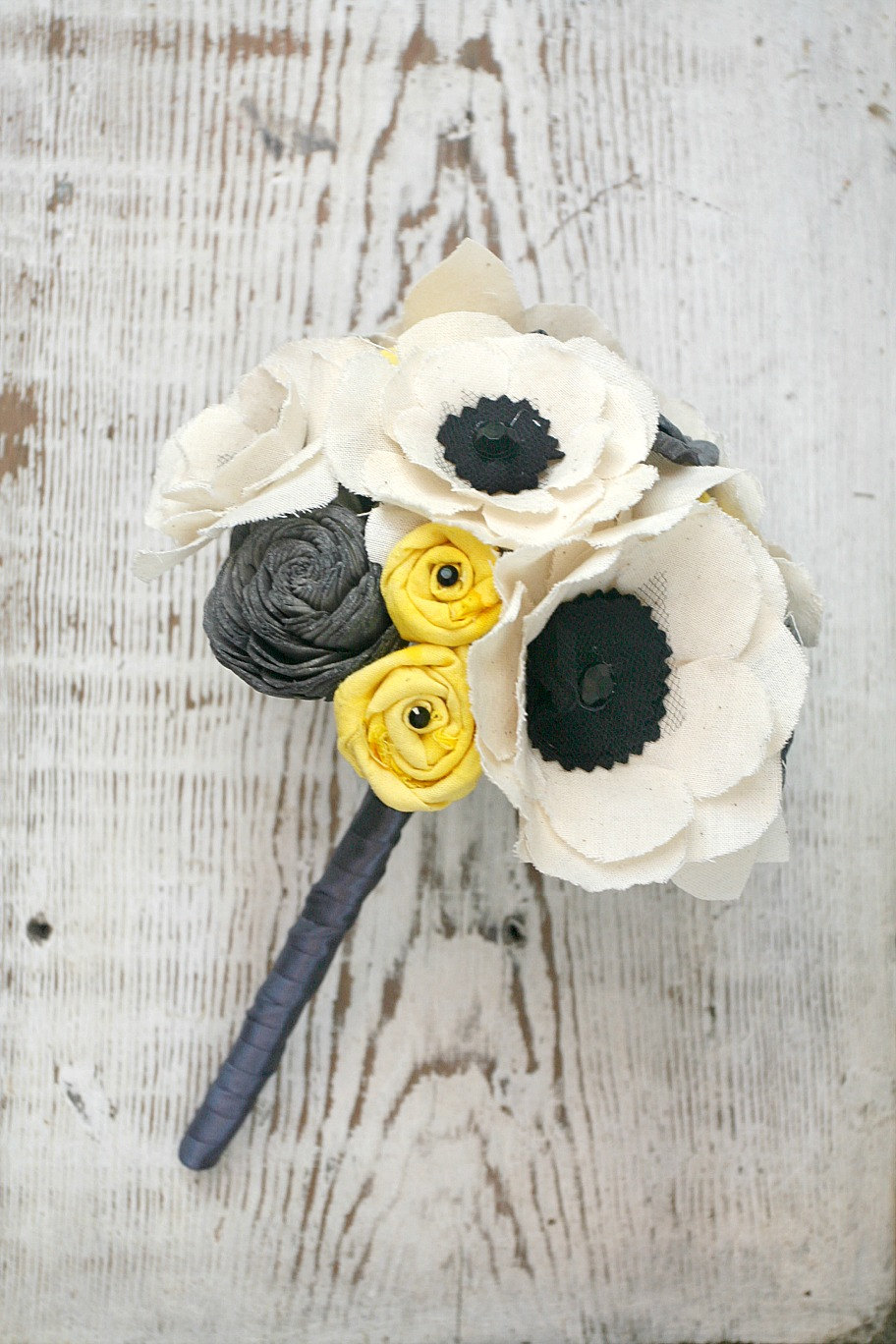 anemone wedding bouquet with black and white and yellow and gray