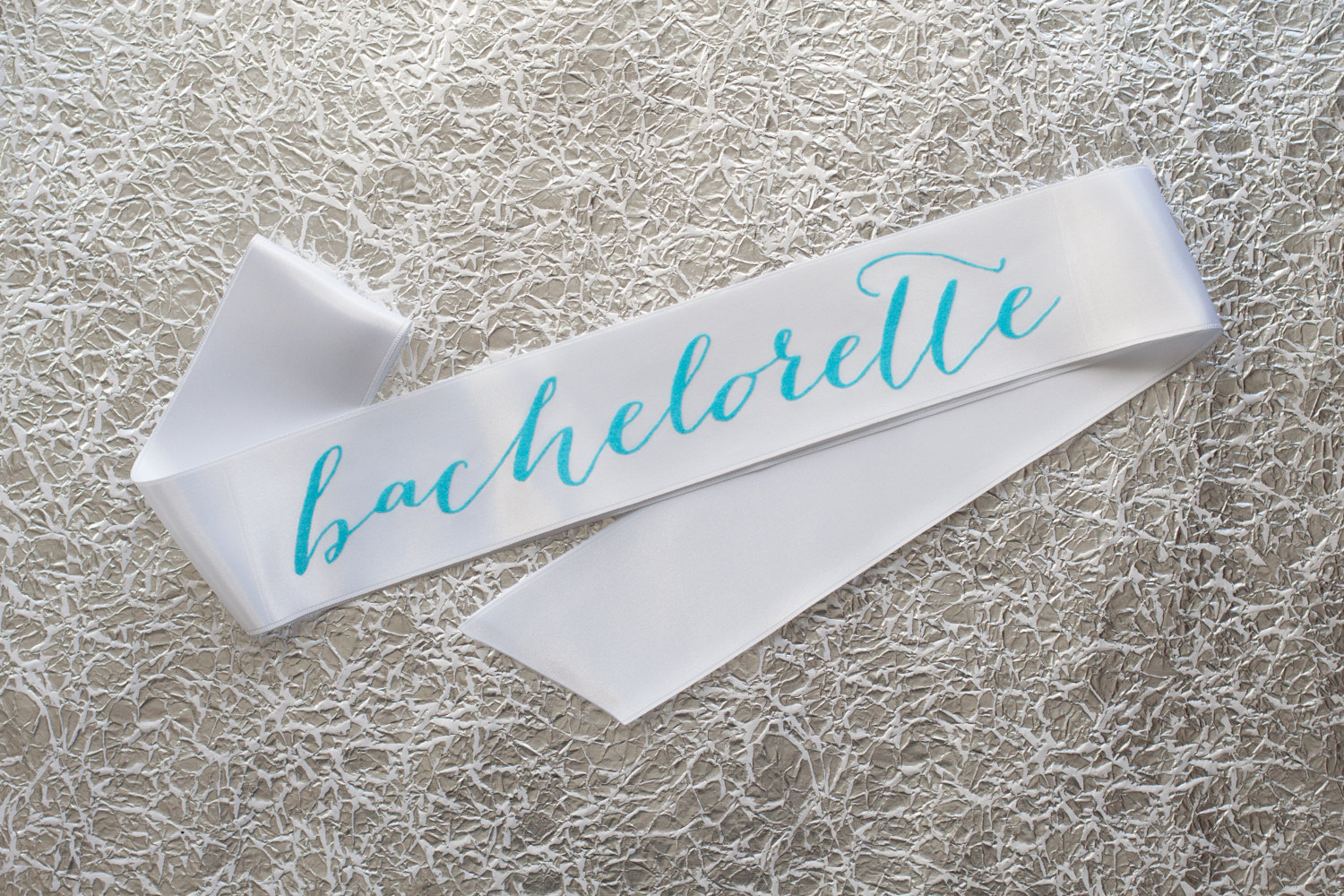 bachelorette sash with aqua writing | stylish bachelorette sash ideas | via https://emmalinebride.com/bride/bachelorette-sash-ideas/