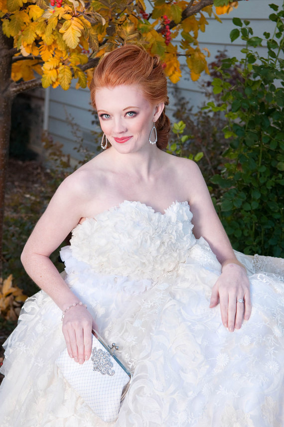 bride holding whitre bridal clutch purse (by angee w)