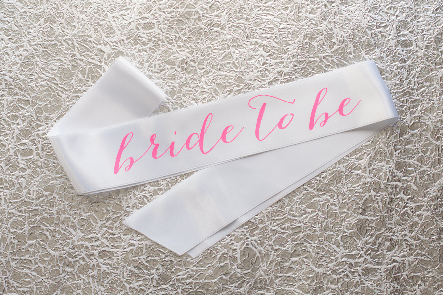 bride to be sash hot pink on white | stylish bachelorette sash ideas | via https://emmalinebride.com/bride/bachelorette-sash-ideas/