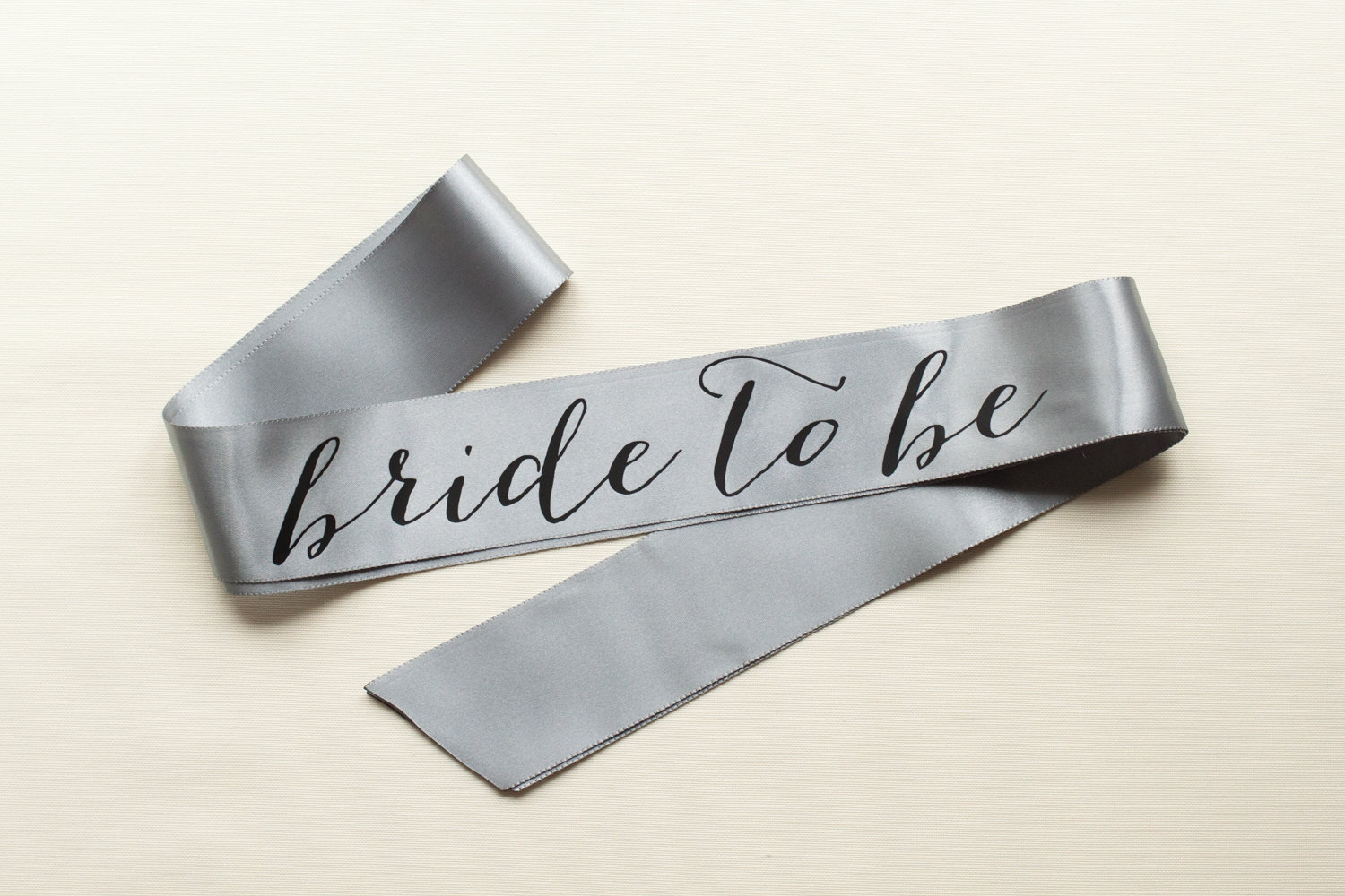 bride to be sash silver with black text | stylish bachelorette sash ideas | via https://emmalinebride.com/bride/bachelorette-sash-ideas/