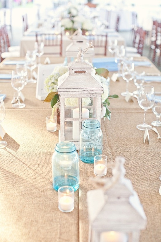 burlap blue mason jars and white lanterns via how to decorate for beach wedding via emmalinebride.com