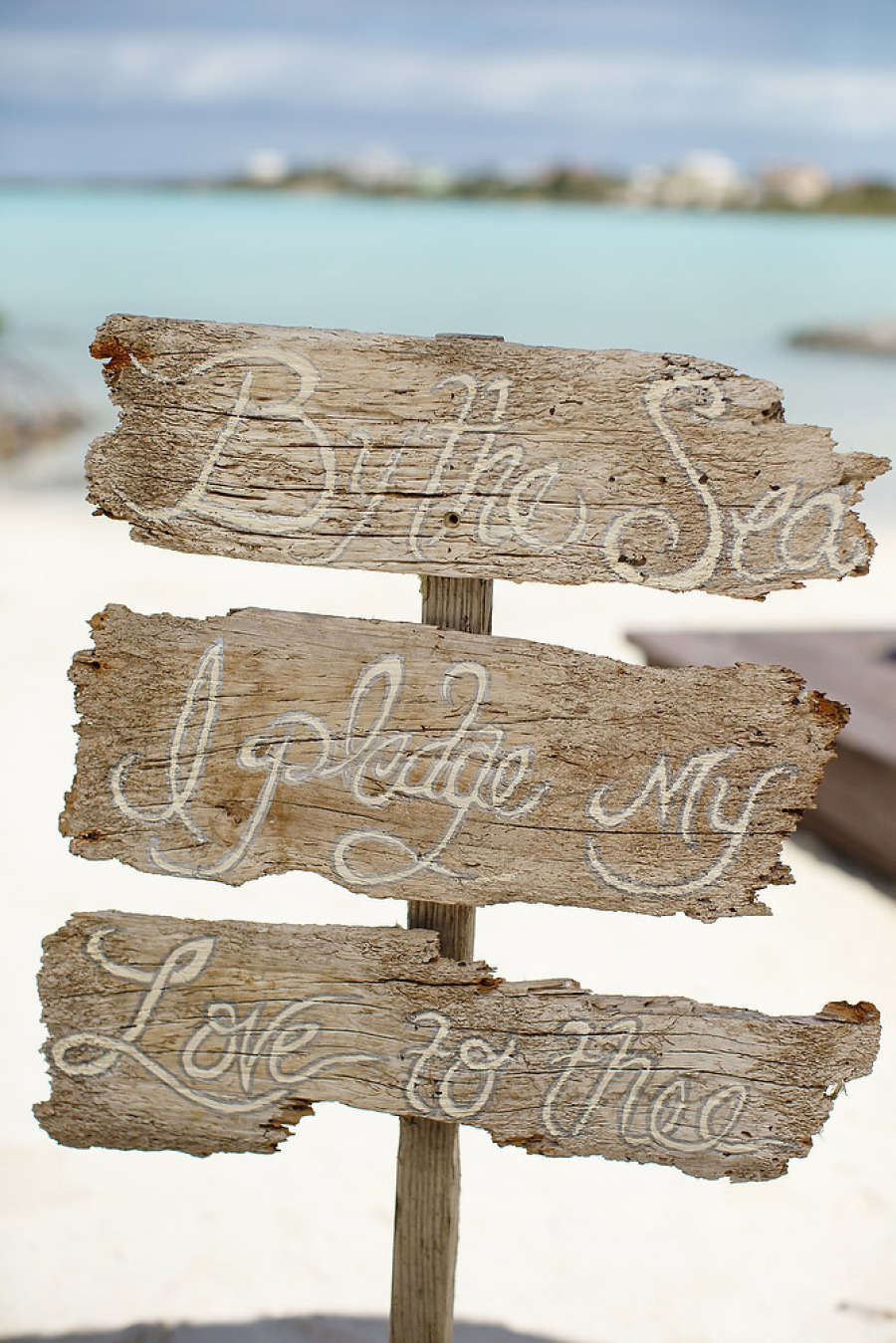 by the sea my love i pledge to thee sign beach wedding | photo: brilliant studios | via emmalinebride.com on how to decorate for beach wedding