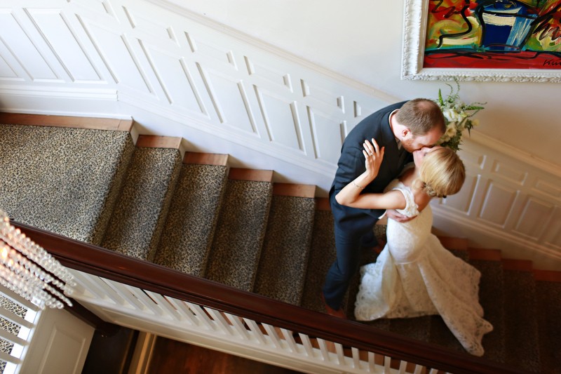 Bride and groom kissing on the stairs | Photographer: Melissa Prosser Photography | via https://emmalinebride.com/real-weddings/colleen-ryans-lovely-savannah-wedding-at-the-mansion-on-forsyth-park