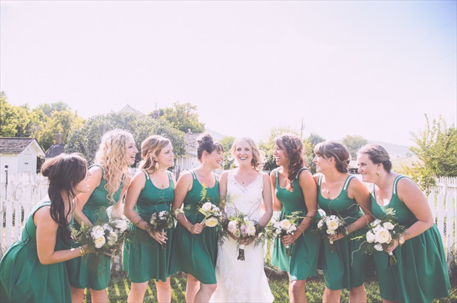 The bridesmaids wore cute short emerald green dresses | Photo: Searching for the Light Photography LLC | via https://emmalinebride.com/real-weddings/colorado-chic-wedding-kendall-brian/