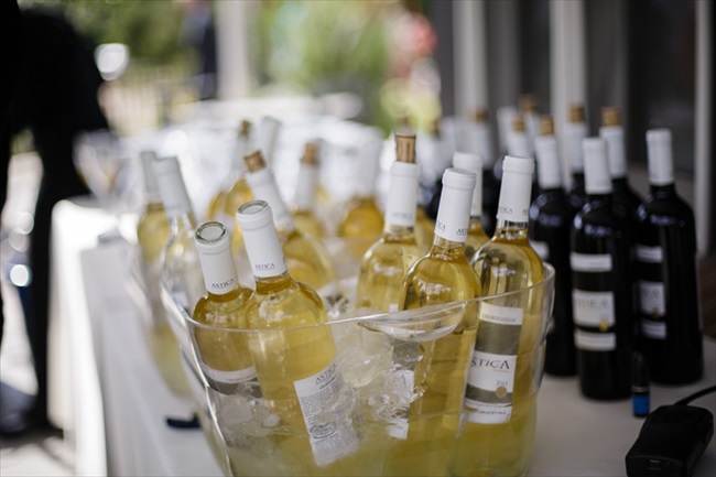 Bottles of wine chilling for the wedding | Photo: Searching for the Light Photography LLC | via https://emmalinebride.com/real-weddings/colorado-chic-wedding-kendall-brian/