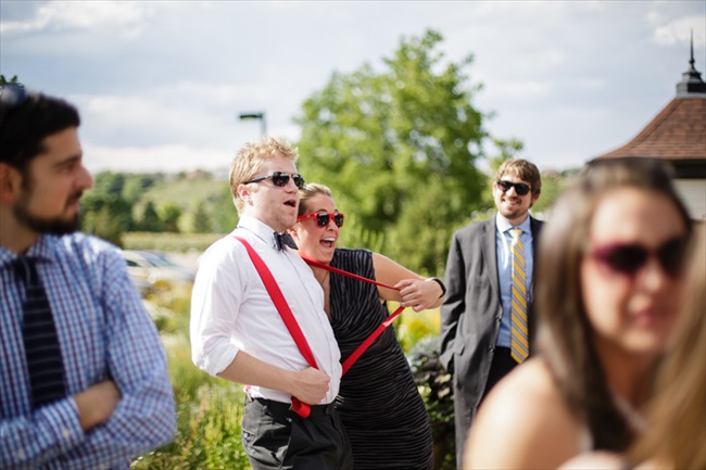 Couple, red suspenders | Photo: Searching for the Light Photography LLC | via https://emmalinebride.com/real-weddings/colorado-chic-wedding-kendall-brian/