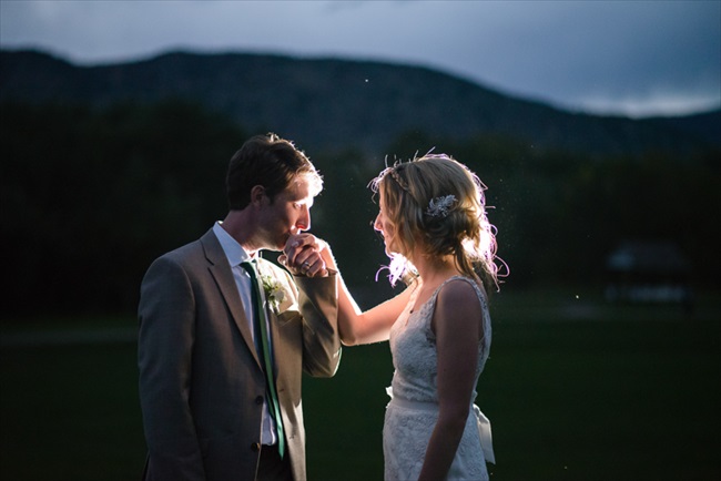 The groom kisses his bride's hand | Photo: Searching for the Light Photography LLC | via https://emmalinebride.com/real-weddings/colorado-chic-wedding-kendall-brian/