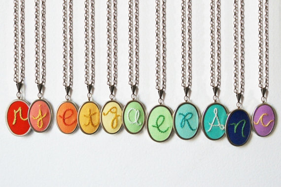 Colorful initial necklaces, hand-embroidered by The Merriweather Council via EmmalineBride.com.