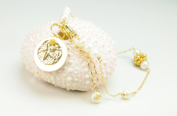 dainty sand dollar bracelet via Beach Wedding Jewelry Ideas for Bridesmaids