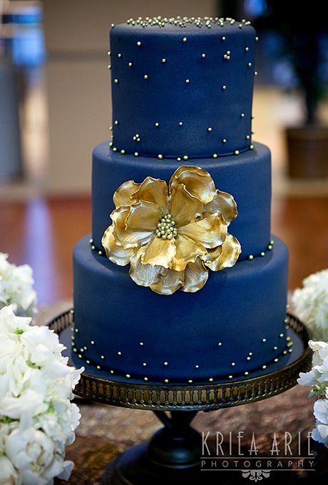 deep blue wedding cake with big gold flower