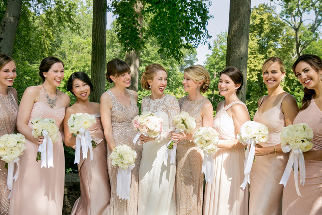 bride and bridesmaids laughing at Connecticut waterfront wedding - photo: Melani Lust Photography | via https://emmalinebride.com