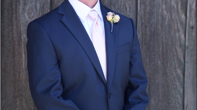 grooms suit and boutineer in their Sova Gardens wedding film