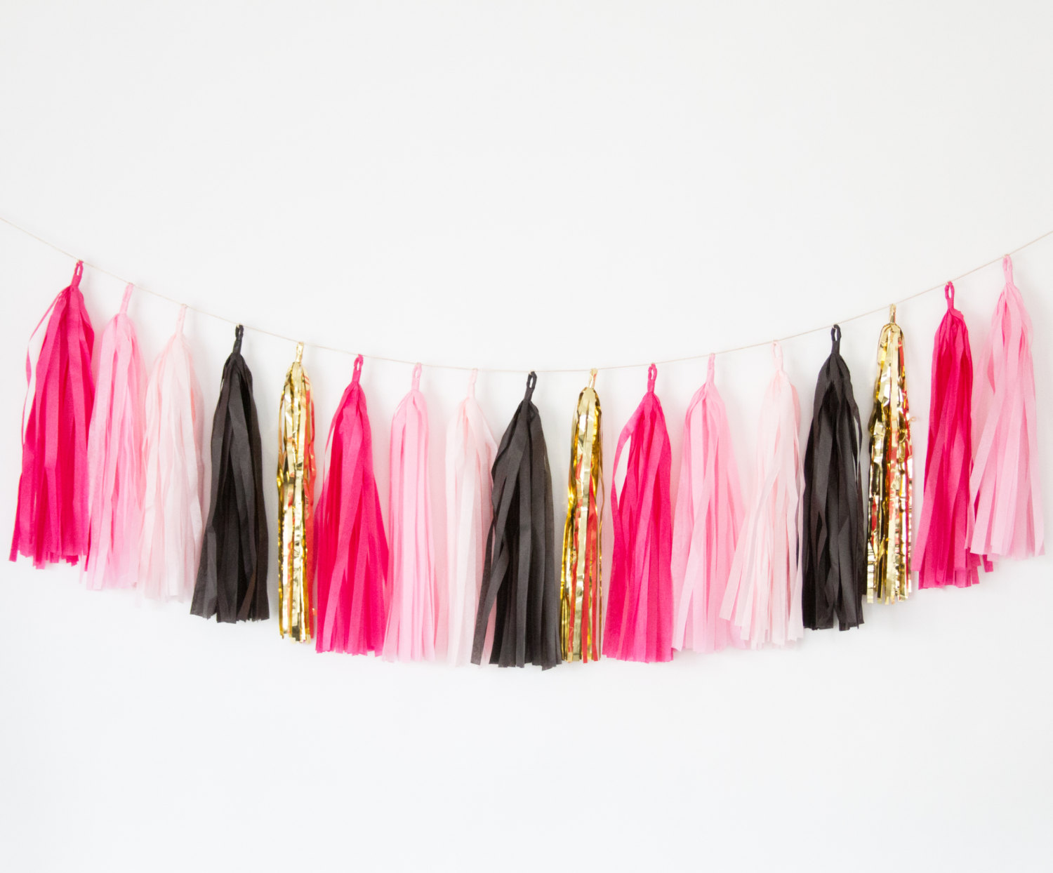 hot pink and black tassel garland by blush bazaar | fun bachelorette party ideas | https://emmalinebride.com/planning/fun-bachelorette-party-ideas/
