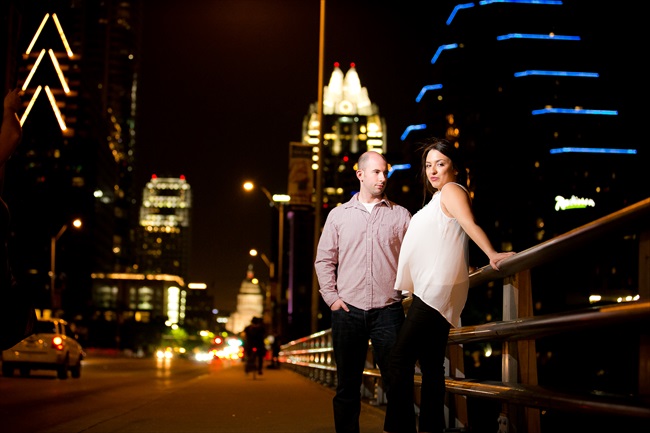couple on bridge with the city skyline at their Fun Austin Engagement Session | Photographer: Adrianne Riley Photography | via https://emmalinebride.com/real-weddings/fun-austin-engagement-session-priscella-jerry/