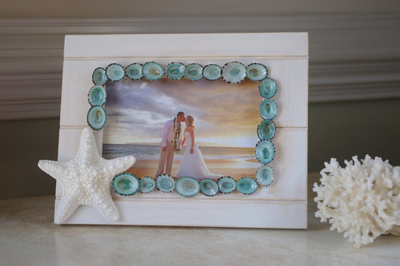 10 Beach Wedding Centerpieces via EmmalineBride.com - limpet shell and starfish frame by By The Seashore