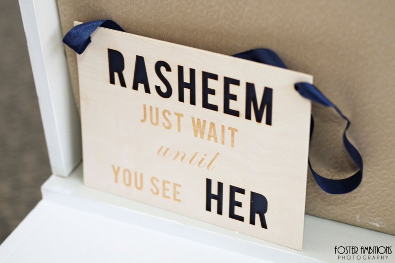 mansion on main street wedding - Flower girl carrying sign that reads, 'Rasheem, just wait until you see her'. Cute!