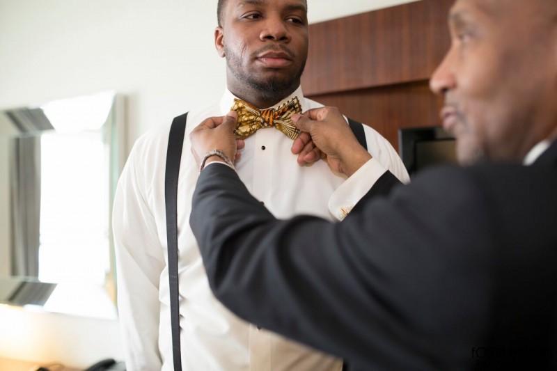 mansion on main street wedding - the groom putting on his bowtie