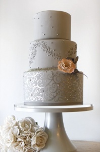 grey wedding cake three tiered with pink flower accent