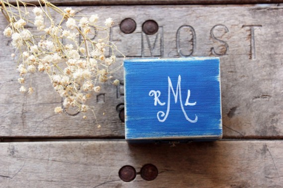 blue ring box with monogram on top | via Rustic Ring Pillows http://emmalinebride.com/ceremony/rustic-ring-pillows/