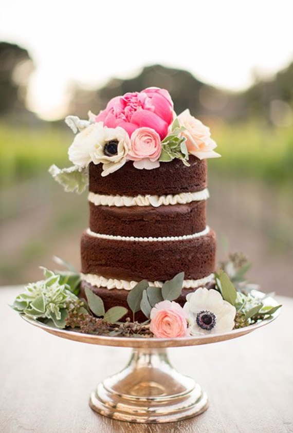 naked wedding cake with peronies, anemones, ranunculus on top