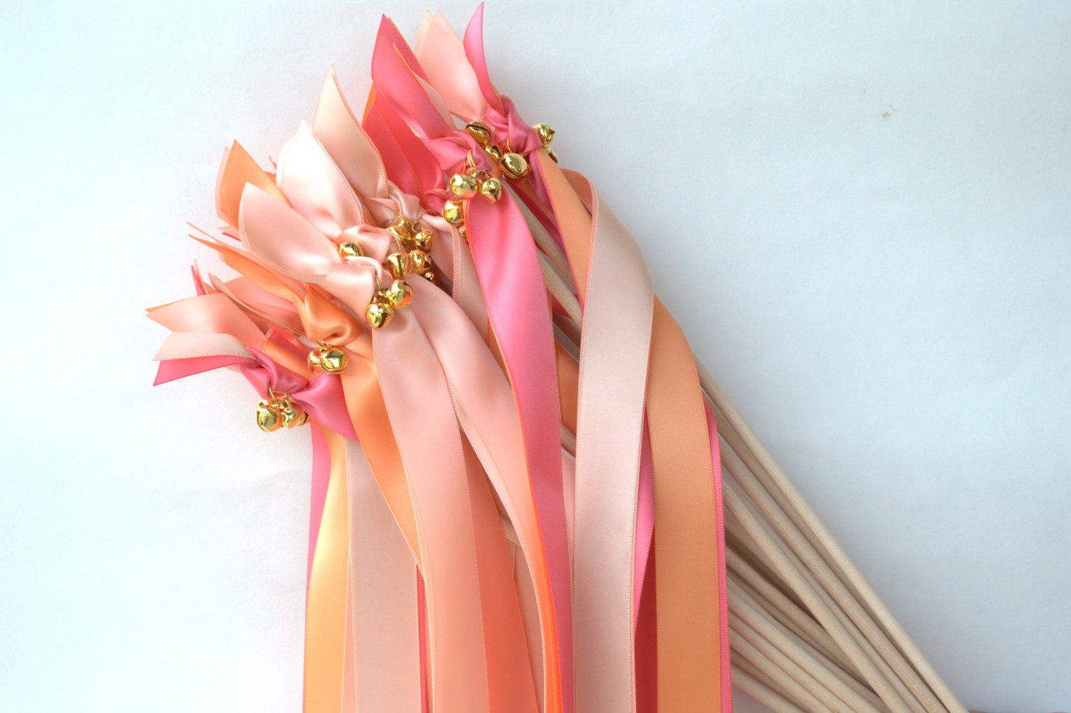 orange pink ribbon wands with bells